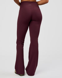 Woman wearing Fusion V-Contour High-Rise Flared Tall Legging Pockets - Cherry Lacquer | Model:Rosie | Size:S