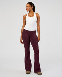 Woman wearing Fusion V-Contour High-Rise Flared Tall Legging Pockets - Cherry Lacquer | Model:Rosie | Size:S