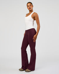 Woman wearing Fusion V-Contour High-Rise Flared Tall Legging Pockets - Cherry Lacquer | Model:Rosie | Size:S
