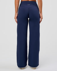 Model wearing Fusion V-Contour High-Rise Petite Pant - Future Navy | Model:Issy | Size:XS