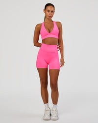 Woman wearing Fusion V-Contour Ultra High-Rise 4” Short Pockets - Sugar Plum | Model:Brylee | Size:XS