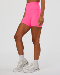 Woman wearing Fusion V-Contour Ultra High-Rise 4” Short Pockets - Sugar Plum | Model:Brylee | Size:XS