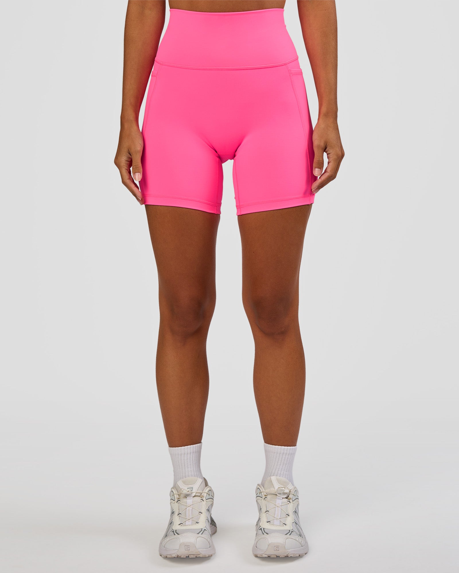 Woman wearing Fusion V-Contour Ultra High-Rise 6" Short Pockets - Sugar Plum | Model:Brylee | Size:XS