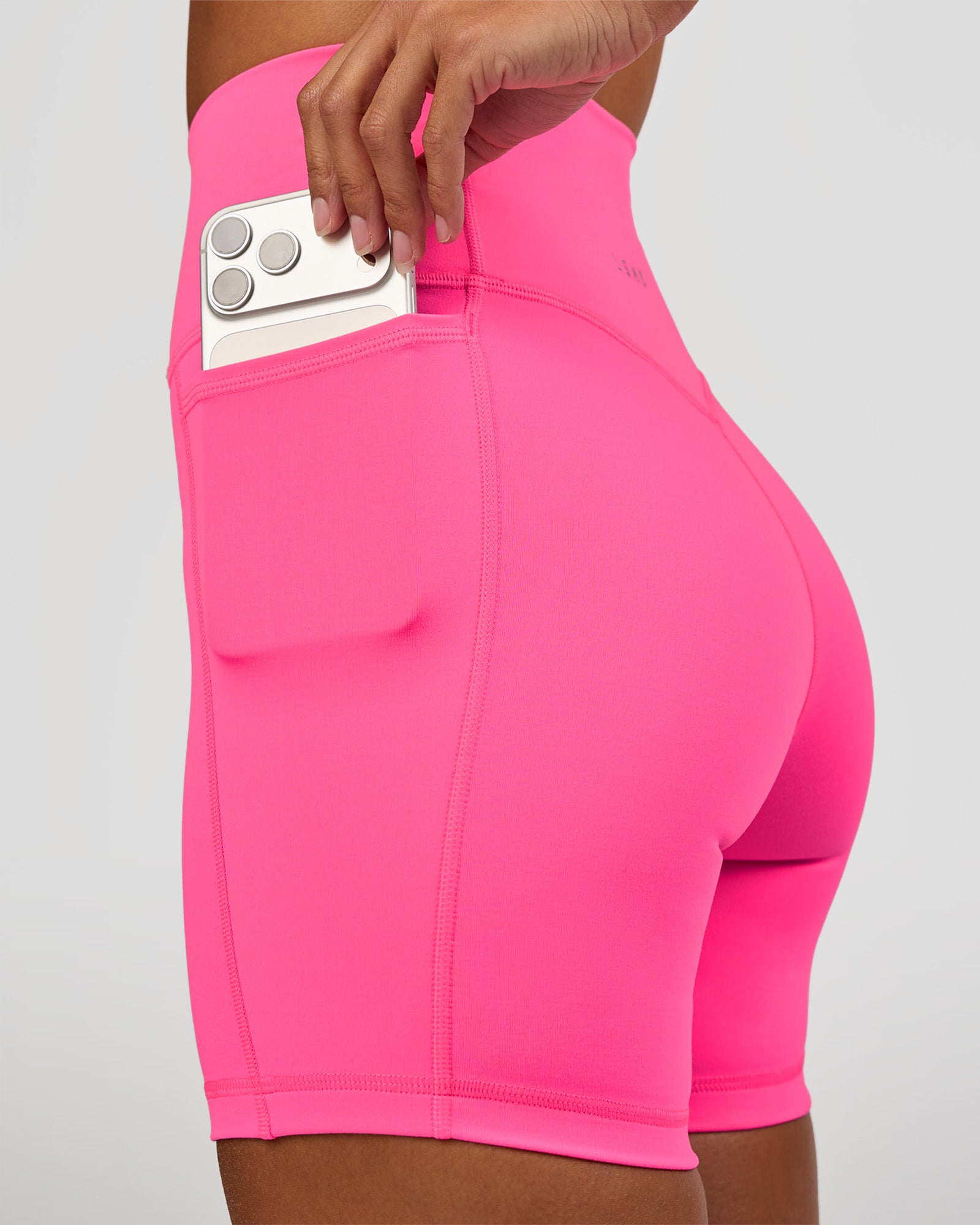 Woman wearing Fusion V-Contour Ultra High-Rise 6" Short Pockets - Sugar Plum | Model:Brylee | Size:XS