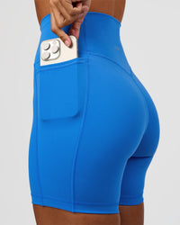 Woman wearing Fusion V-Contour Ultra High-Rise 6" Short Pockets - Palace Blue | Model:Brylee | Size:XS