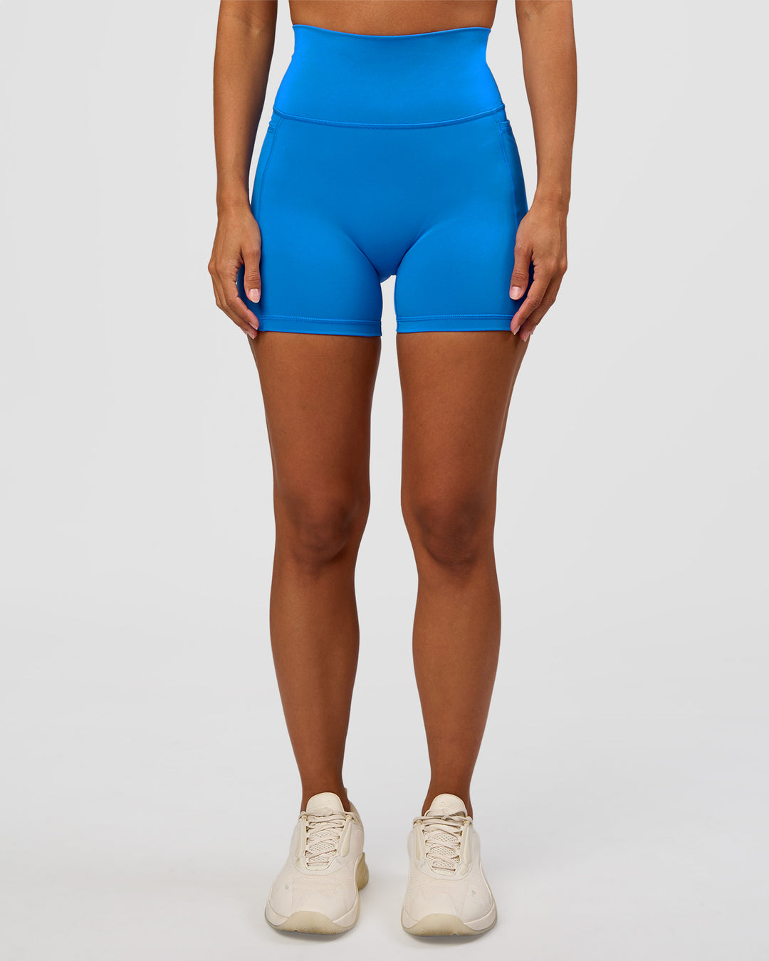 Woman wearing Fusion V-Contour Ultra High-Rise 4" Short Pockets - Palace Blue | Model:Brylee | Size:XS - view 1