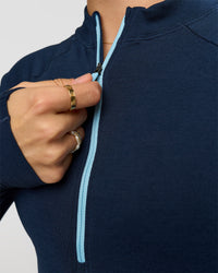 Woman wearing GG AeroFLX+ Long Sleeve Half Zip - Future Navy-Baltic Sea | Model:Grace | Size:XS