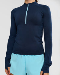 Woman wearing GG AeroFLX+ Long Sleeve Half Zip - Future Navy-Baltic Sea | Model:Grace | Size:XS