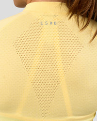 Woman wearing GG AeroFLX+ Long Sleeve Half Zip - Lemon-Baltic Sea | Model:Grace | Size:XS