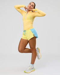 Woman wearing GG AeroFLX+ Long Sleeve Half Zip - Lemon-Baltic Sea | Model:Grace | Size:XS