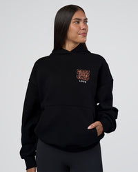 Woman wearing GTC CVC Fleece Unisex Oversized Hoodie - Black-Cantaloupe | Model:Rhiley | Size:XS