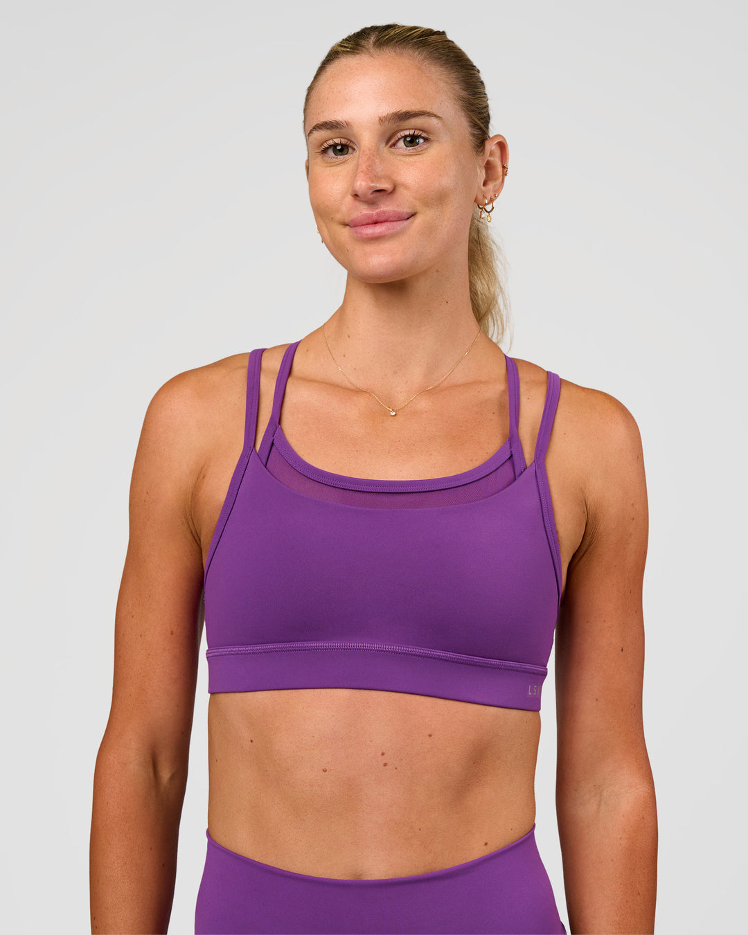 Woman wearing Genesis Layered Sports Bra - Fresh Purple | Model:Emelia | Size:XS