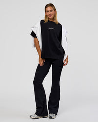 Woman wearing Go-To 1% Better Every Day FLXCotton Oversized Tee - Black-White | Model:Amity | Size:XS