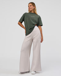 Woman wearing Go-To 1% Better Every Day FLXCotton Oversized Tee - Carbon Green Washed-White | Model:Amity | Size:XS