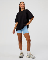 Woman wearing Go-To Break Through FLXCotton Oversized Tee - Black-Open Air | Model:Brylee | Size:XS