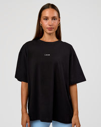 Woman wearing Go-To Break Through FLXCotton Oversized Tee - Black-Open Air | Model:Brylee | Size:XS