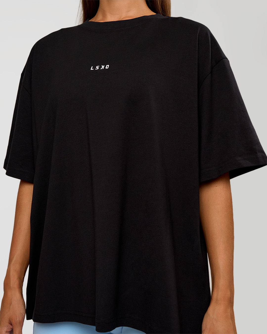 Woman wearing Go-To Break Through FLXCotton Oversized Tee - Black-Open Air | Model:Brylee | Size:XS