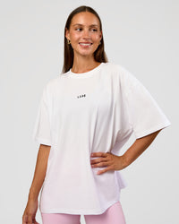 Woman wearing Go-To Break Through FLXCotton Oversized Tee - White-Marshmallow | Model:Brylee | Size:XS
