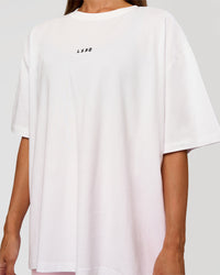 Woman wearing Go-To Break Through FLXCotton Oversized Tee - White-Marshmallow | Model:Brylee | Size:XS