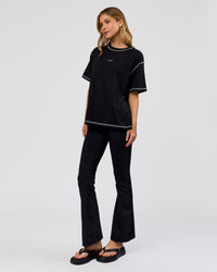 Woman wearing Go-To Contrast Oversized Heavyweight FLXCotton Tee - Black-White | Model:Leilani | Size:XS