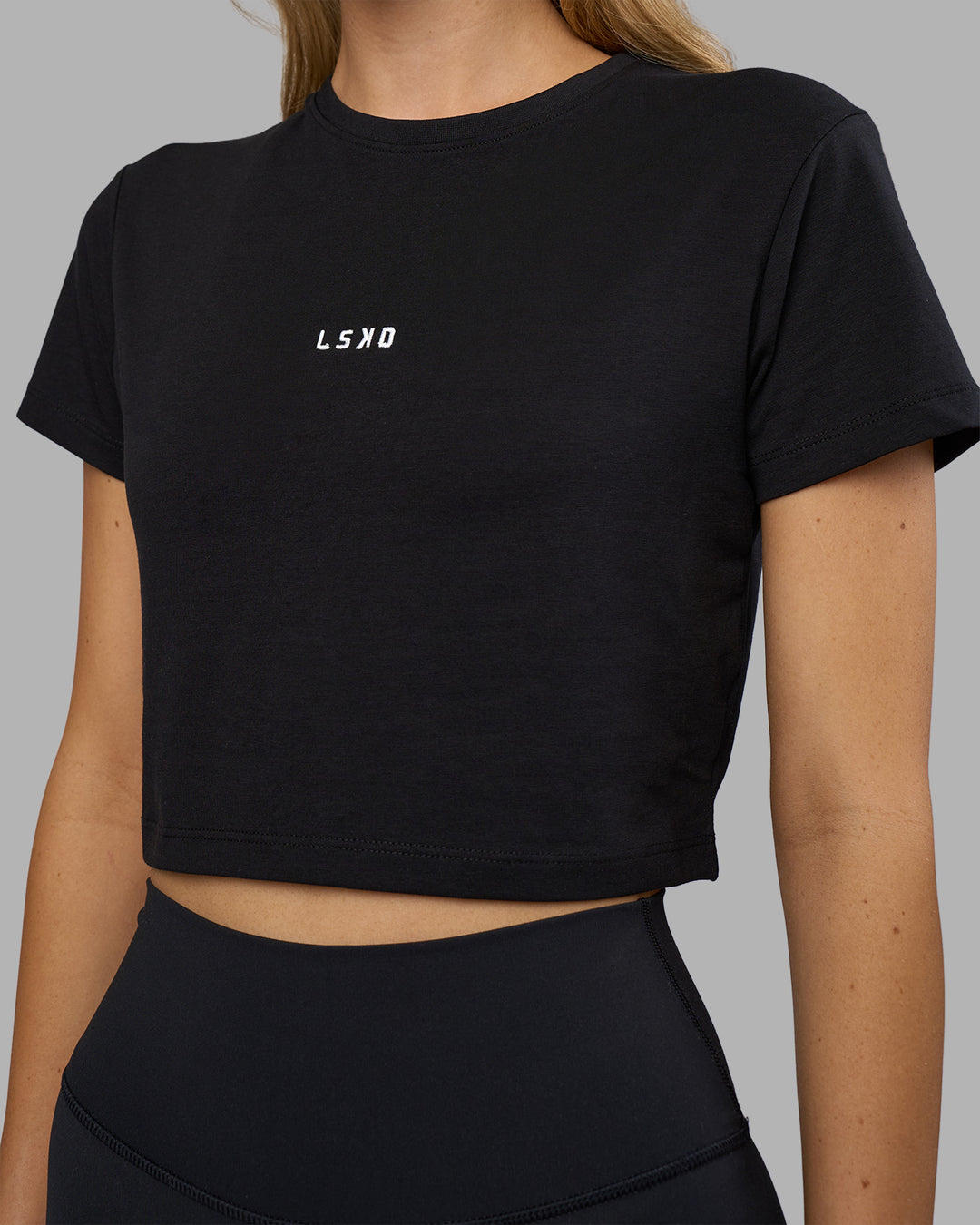 Woman wearing Go-To FLXCotton Baby Tee - Black-White | Model:Leilani | Size:XS