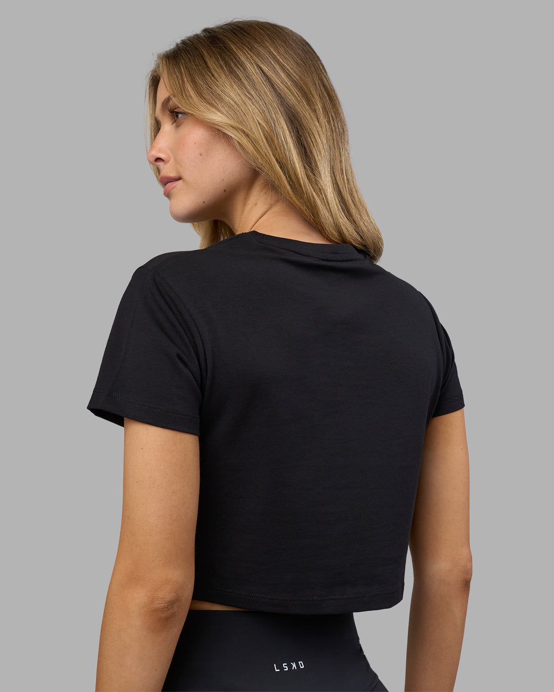 Woman wearing Go-To FLXCotton Baby Tee - Black-White | Model:Leilani | Size:XS