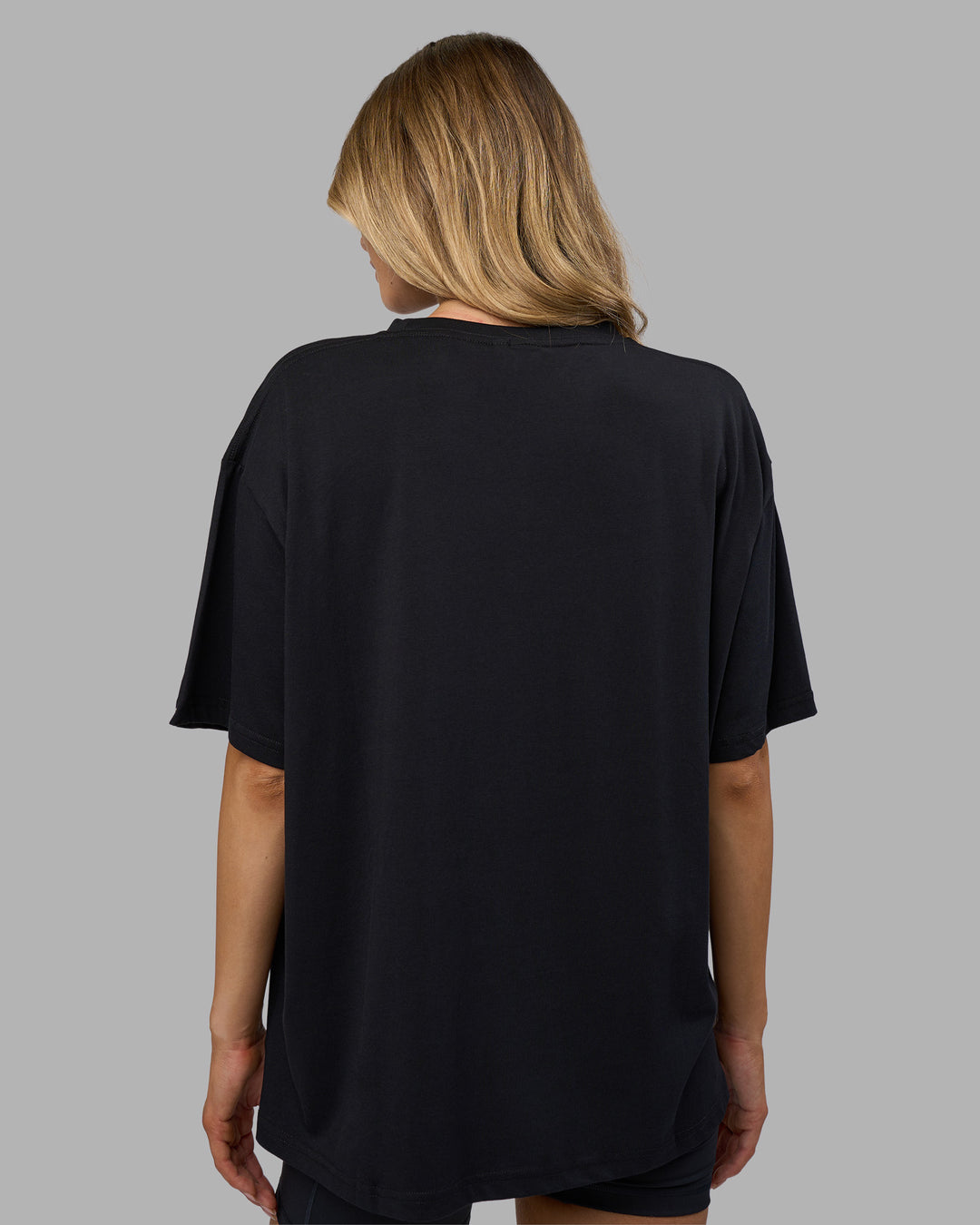 Woman wearing Go-To FLXCotton Oversized Tee - Black-White | Model:Leilani | Size:XS