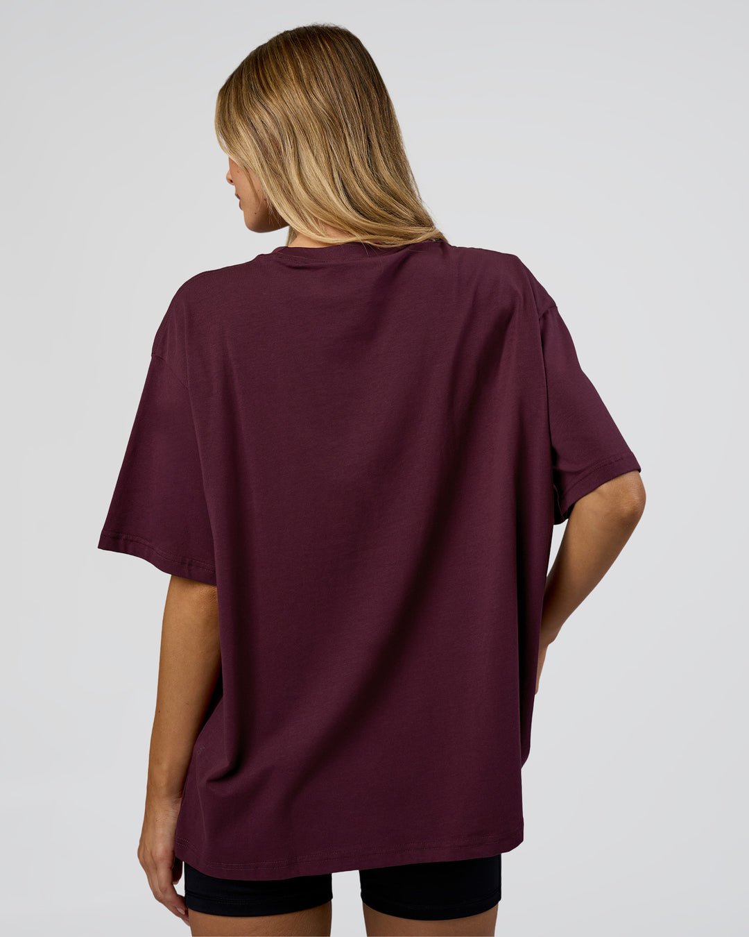 Woman wearing Go-To FLXCotton Oversized Tee - Cherry Lacquer-White | Model:Leilani | Size:XS