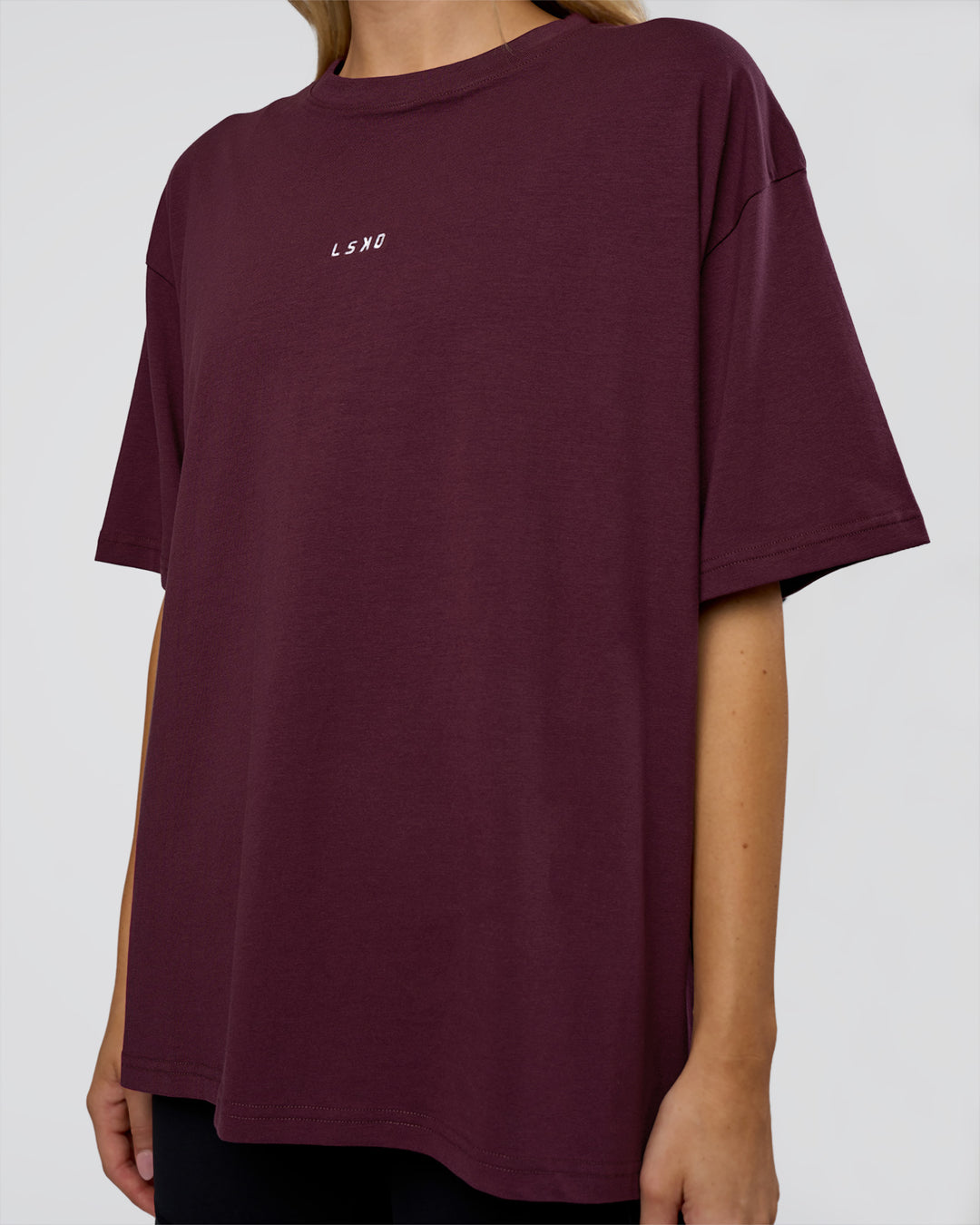 Woman wearing Go-To FLXCotton Oversized Tee - Cherry Lacquer-White | Model:Leilani | Size:XS
