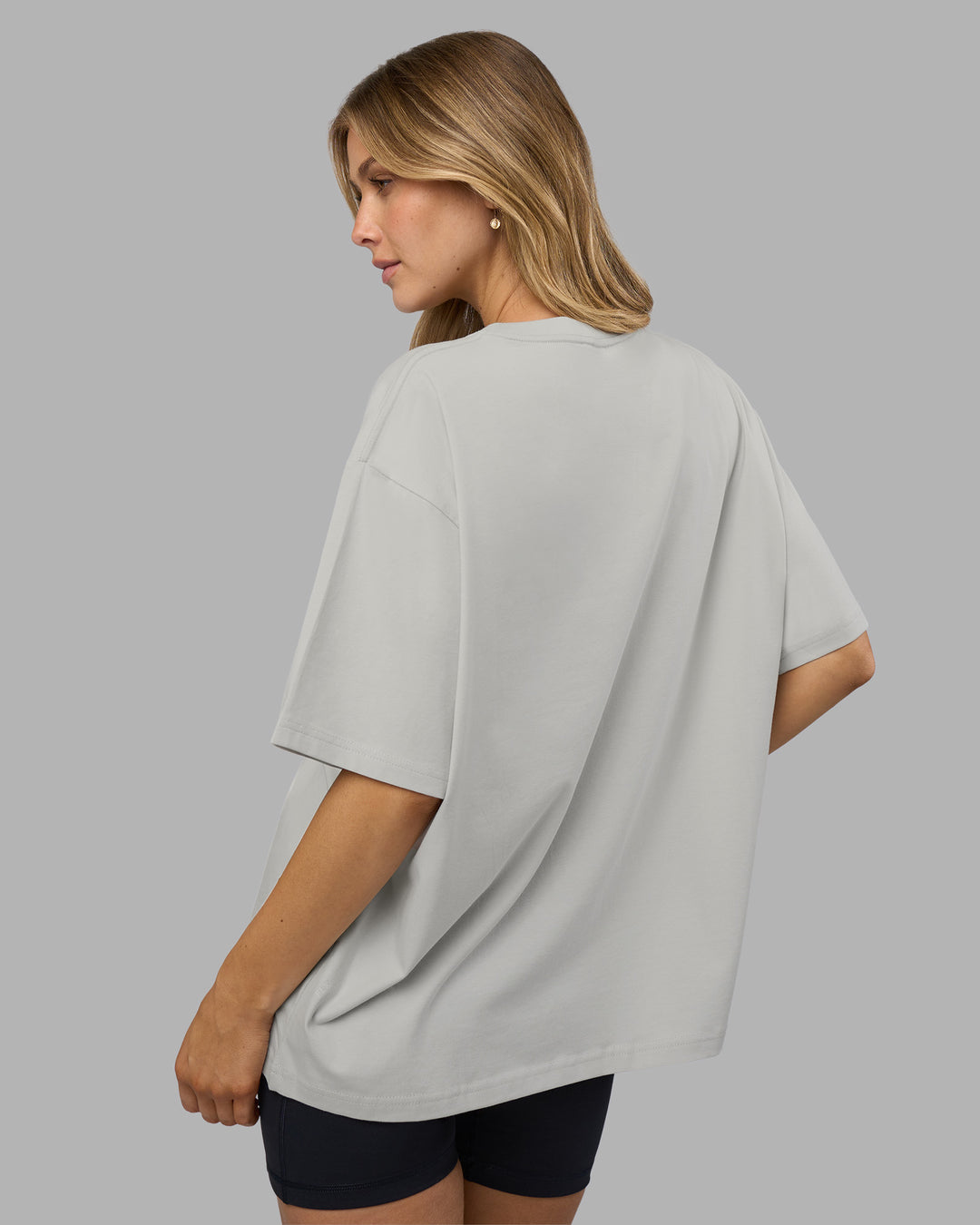Woman wearing Go-To FLXCotton Oversized Tee - Digital Mist-White | Model:Leilani | Size:XS