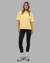 Woman wearing Go-To FLXCotton Oversized Tee - Lemon-White | Model:Leilani | Size:XS