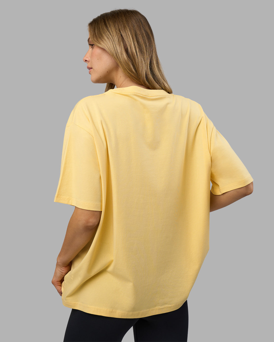 Woman wearing Go-To FLXCotton Oversized Tee - Lemon-White | Model:Leilani | Size:XS