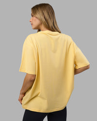 Woman wearing Go-To FLXCotton Oversized Tee - Lemon-White | Model:Leilani | Size:XS