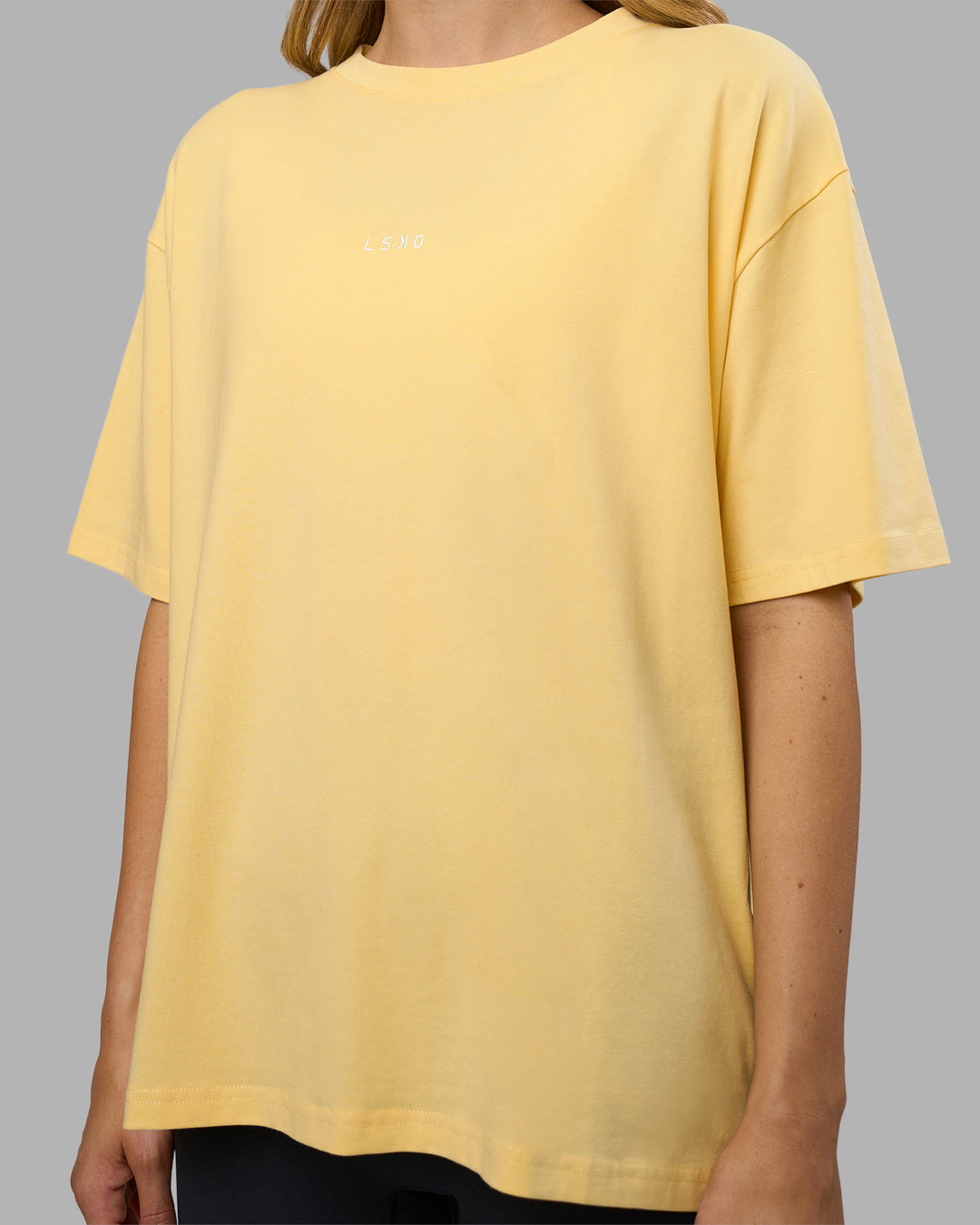 Woman wearing Go-To FLXCotton Oversized Tee - Lemon-White | Model:Leilani | Size:XS