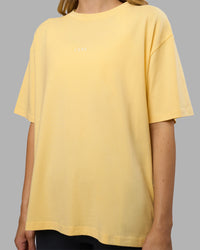 Woman wearing Go-To FLXCotton Oversized Tee - Lemon-White | Model:Leilani | Size:XS