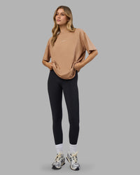 Woman wearing Go-To FLXCotton Oversized Tee - Warm Smoke-White | Model:Leilani | Size:XS