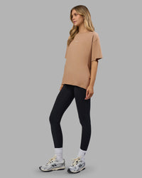 Woman wearing Go-To FLXCotton Oversized Tee - Warm Smoke-White | Model:Leilani | Size:XS