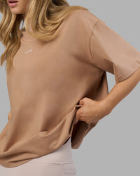 Woman wearing Go-To FLXCotton Oversized Tee - Warm Smoke-White | Model:Leilani | Size:XS