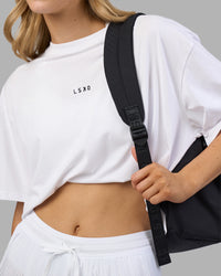 Woman wearing Go-To FLXCotton Oversized Tee - White-Black | Model:Leilani | Size:XS