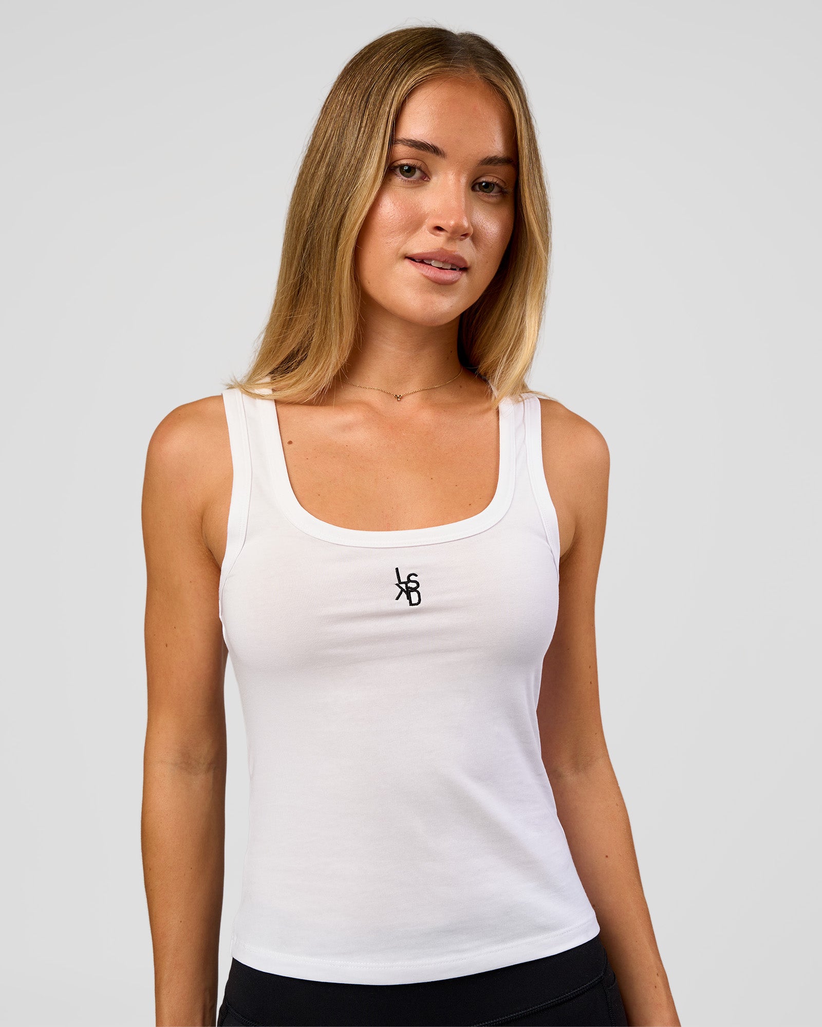Woman wearing Go-To FLXCotton Scoop Neck Tank in White-Black | Model:Issy | Size:XS