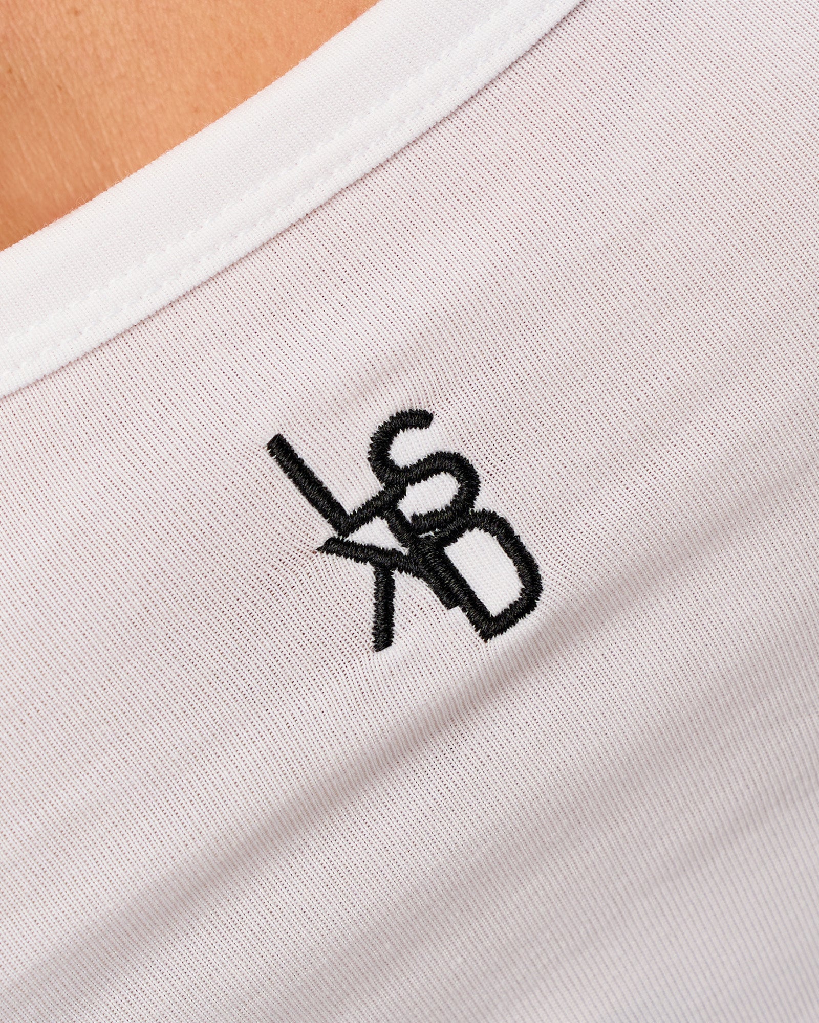 Woman wearing Go-To FLXCotton Scoop Neck Tank in White-Black | Model:Issy | Size:XS