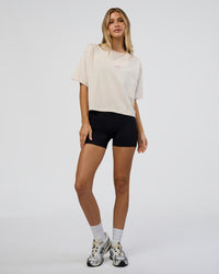 Woman wearing Go-To Heavy Weight FLXCotton Graphic Skimmer Tee - Off White-Multi | Model:Leilani | Size:XS