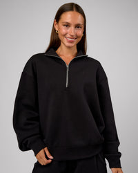 Woman wearing Go-To Oversized Quarter Zip Sweater - Black | Model:Brylee | Size:XS