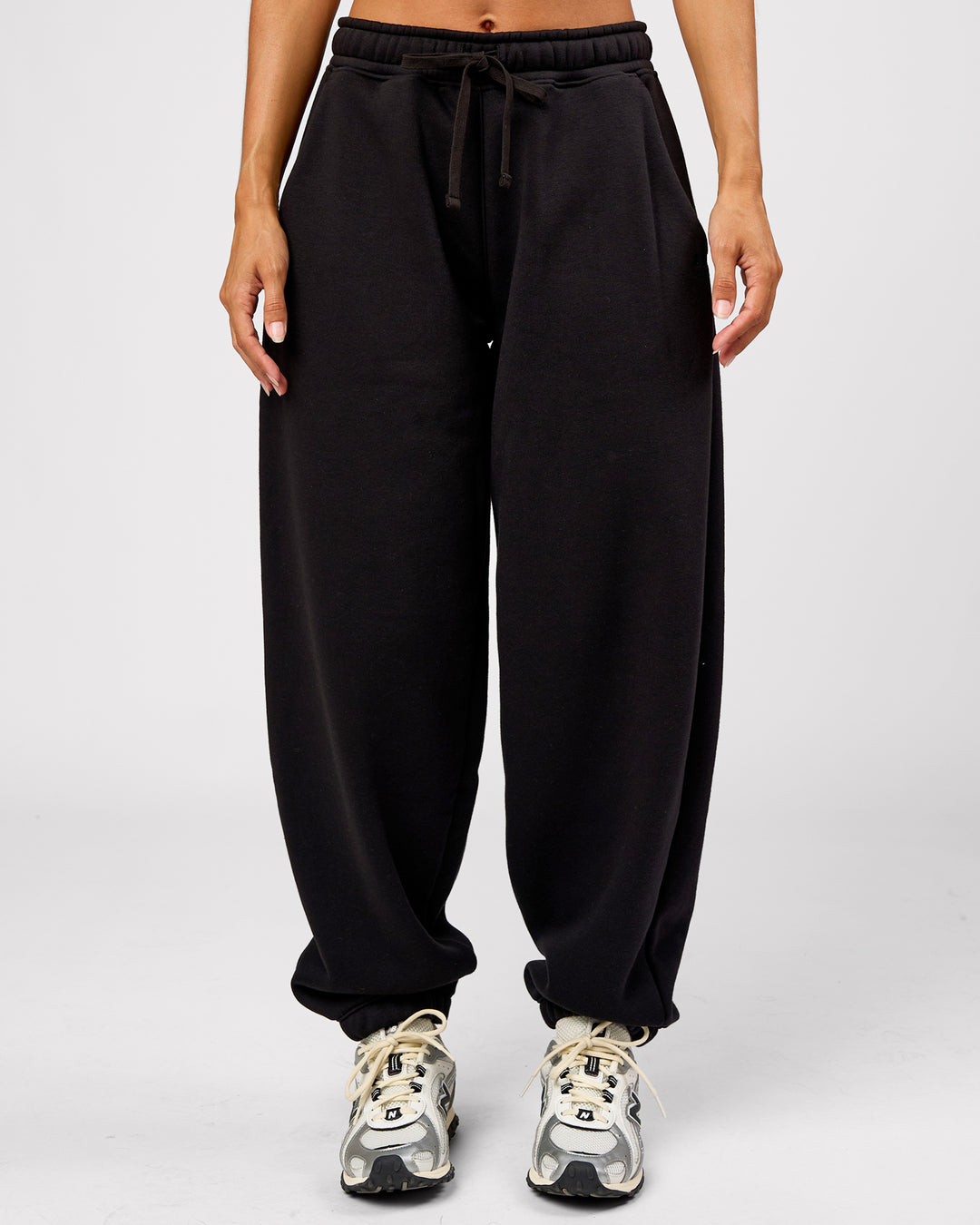 Woman wearing Go-To Oversized Track Pant - Black | Model:Brylee | Size:XS - view 1
