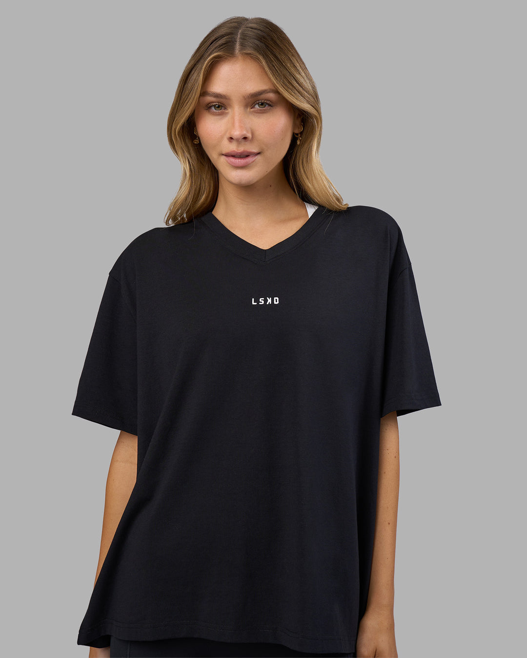 Woman wearing Go-To V-Neck FLXCotton Oversized Tee - Black-White | Model:Leilani | Size:XS