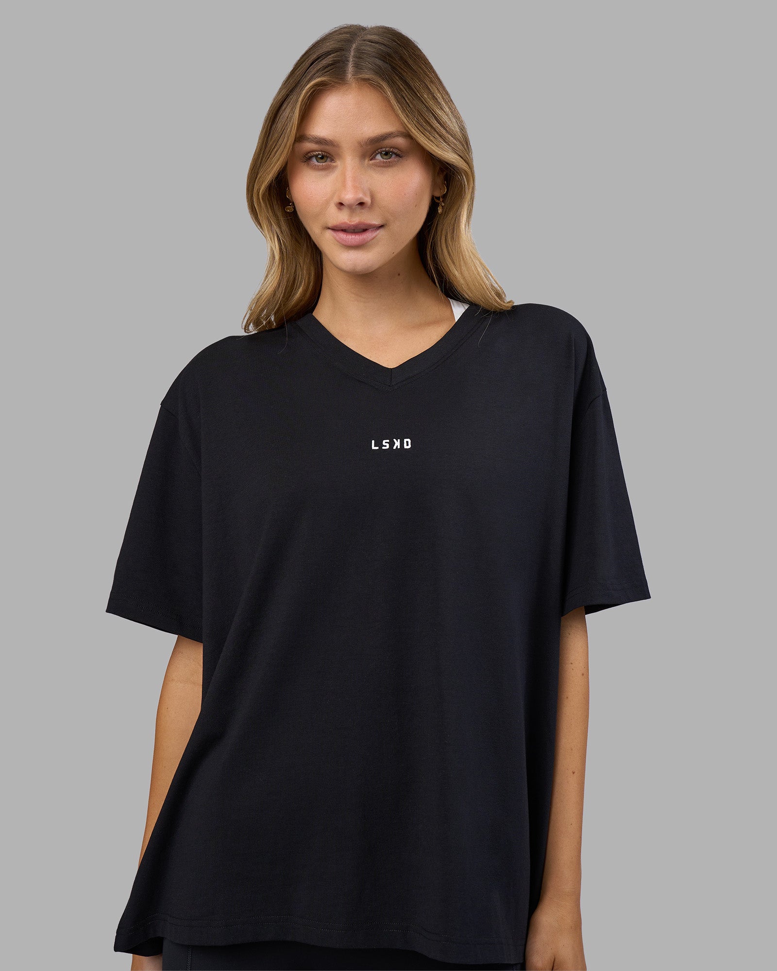 Woman wearing Go-To V-Neck FLXCotton Oversized Tee - Black-White | Model:Leilani | Size:XS