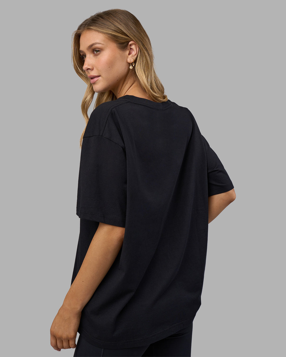 Woman wearing Go-To V-Neck FLXCotton Oversized Tee - Black-White | Model:Leilani | Size:XS