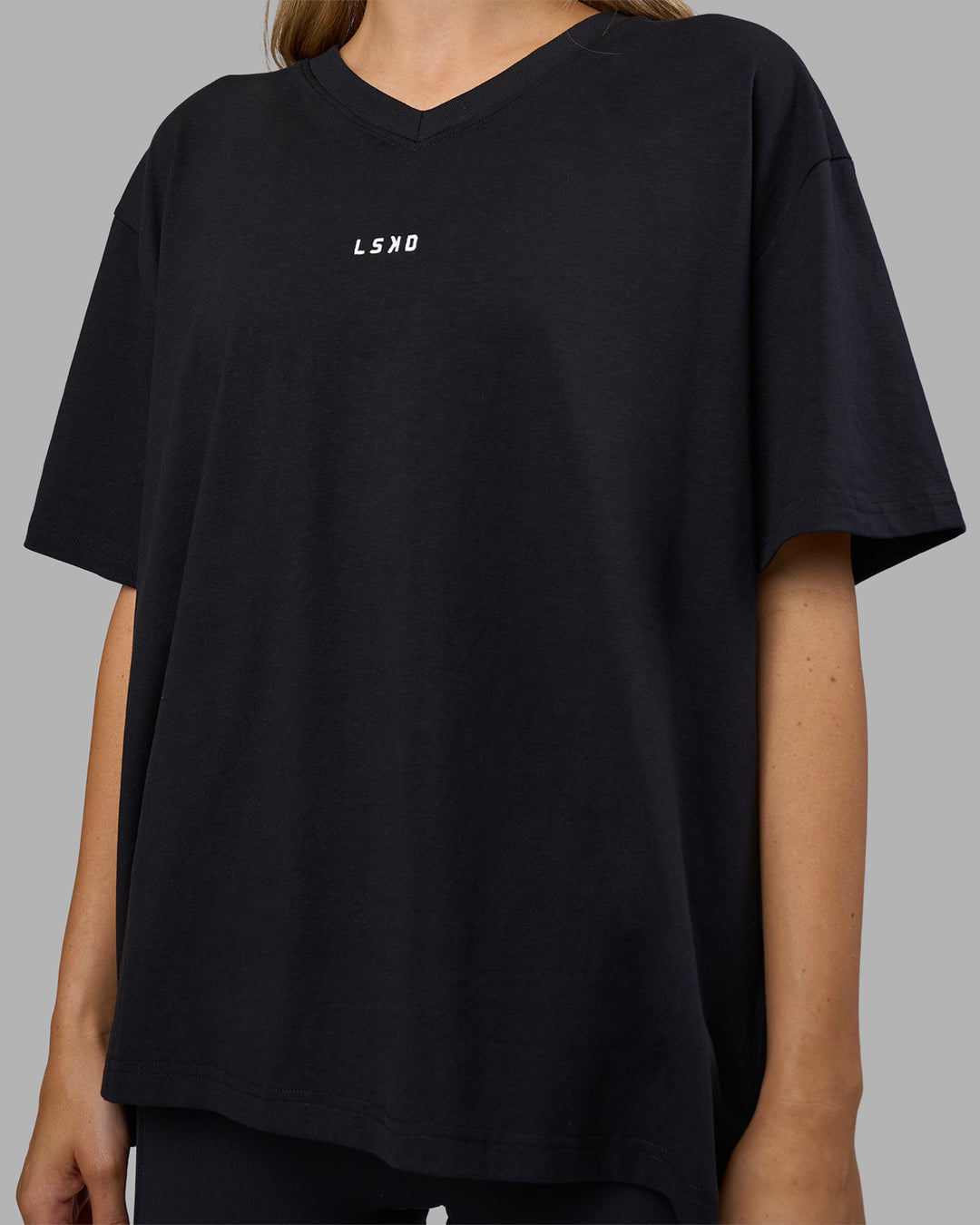 Woman wearing Go-To V-Neck FLXCotton Oversized Tee - Black-White | Model:Leilani | Size:XS