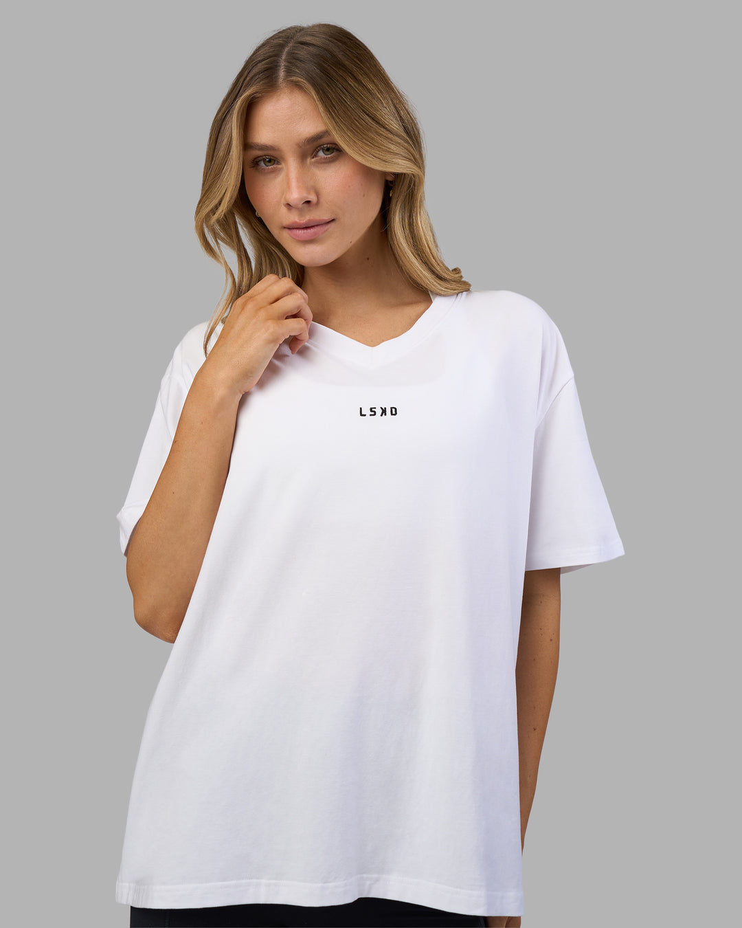 Woman wearing Go-To V-Neck FLXCotton Oversized Tee - White-Black | Model:Leilani | Size:XS