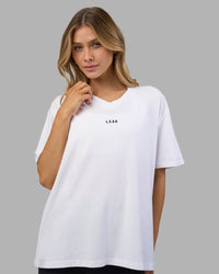 Woman wearing Go-To V-Neck FLXCotton Oversized Tee - White-Black | Model:Leilani | Size:XS